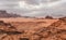 Red orange Mars like landscape in Jordan Wadi Rum desert, mountains background, overcast morning. This location was used as set