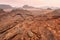 Red orange Mars like landscape in Jordan Wadi Rum desert, mountains background, overcast morning. This location was used as set