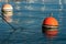 Red and orange mooring buoys in the port