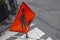 Red orange street sign on stand icon of men at work