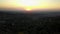 Red orange sunset against the TV tower. Visible clouds, the sun sets over the horizon.