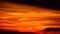 Red orange yellow flame cloud on sunset sky and silhouette dark cloud