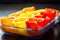 Red, orange and yellow peppers getting prepared for cooking