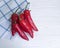 Red organic pepper fresh on a white wooden towel