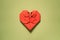 red origami paper heart on green background, valentines day greeting card