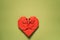 Red origami paper heart on green background, valentines day greeting card