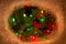 Red ornament hanging on fir tree branch with lights and surround