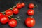 Red pachino tomatoes grape on a bÃ²ack wooden background