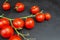 Red pachino tomatoes grape on a bÃ²ack wooden background