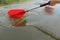 Red paddles for white water rafting and kayaking. Close up of a hand with red paddle kayaking or rafting on the river, concept of