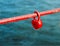 Red padlock in the form of heart on fence