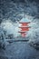 Red Pagoda at Kiyomizu-dera temple with tree covered white snow background.