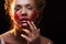 Red paint is like blood on the skin, face art and creative makeup,