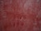 Red painted grunge wall with bumps and scratches, modern interior decoration abstract background