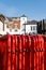 Red Painted Metal Crowd Safety Control Barriers Stacked On The Roadside