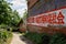 Red-painted slogan on stone wall of wayside building,China