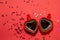 Red pair of mugs of coffee in shape of heart on red background with sparkles hearts. Valentine`s day concept, symbol of love and