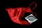 Red panties and condom on black