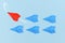 Red paper airplane flying out of line leading blue airplanes. Concept for new business strategies, leadership, discover