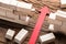 Red Paper Arrow Amidst Blocks On Wooden Table