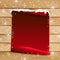 Red paper with bent corner on wooden background with snowflakes