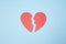 Red paper broken heart on bright background. Divorce, parting