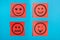 Red paper with faces with emotions on a blue board, message board . Paper stick