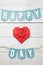 Red paper folded origami heart, happy love day banner garland nice inscription on white barn wood planks background. St.