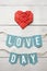 Red paper folded origami heart, love day banner garland nice inscription lettering on white barn wood planks background. St.