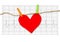 Red paper heart hanging on the clothesline on electrocardiogram.