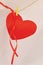 Red paper heart shape hanging on cloth line