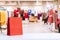 Red paper shopping bags with abstract blurred background of interior clothing store at Mall