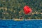 Red parasail wing pulled by a boat on lake Tahoe in California, USA
