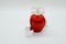 Red parfume bottle on white background with clear cap
