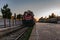 A red passenger train on the railroad, ready for the journey