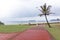 Red Paved Path Leading to Beach