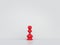 Red pawn stands alone against white background