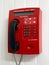 Red payphone hanging on the wall