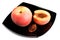 Red peaches with pip on black dish