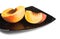 Red peaches slices on black dish