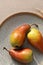 Red pears on plate closeup, minimal aesthetic autumn food still life