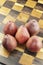 Red Pears on a Wooden Chess Board