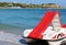 Red pedalo boat with slide on the beach