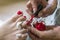 Red pedicure. Master paints female toenails with red varnish