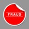 Red peel sticker label with word fraud on gray background