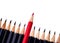 Red pencil standing out from crowd of plenty identical black fellows on white background. business success concept