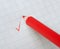 Red pencil writing a mark