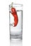 Red pepper dropped into water glass