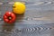 Red pepper is standing and the yellow pepper lies on a wooden background