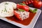 Red pepper stuffed with rice, minced meat and vegetable in tomato sauce with steamed dumpling